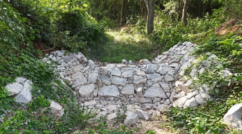 This boulder check dam increases soul moisture & minimizes erosion